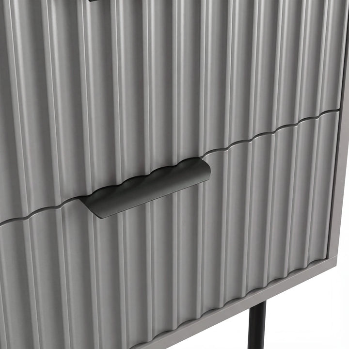 [Grey] Close detail of the black metallic handle fixed to the grey flutrina design drawer surface of a nightstand