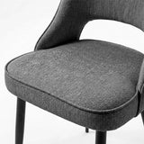 [Grey | Set of 2] Comfy dining chair close-up of fabric seat, piped edge, curved open back and black metal legs.