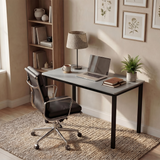 [120 X 50 cm] Computer Desk in a sunlit study corner with leather chair, laptop, table lamp, fern plant, books, and framed botanical artwork