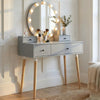 [Grey] Dressing Table With Drawers styled with perfume bottles, makeup brushes, eucalyptus stems, and illuminated Hollywood mirror in a panelled room