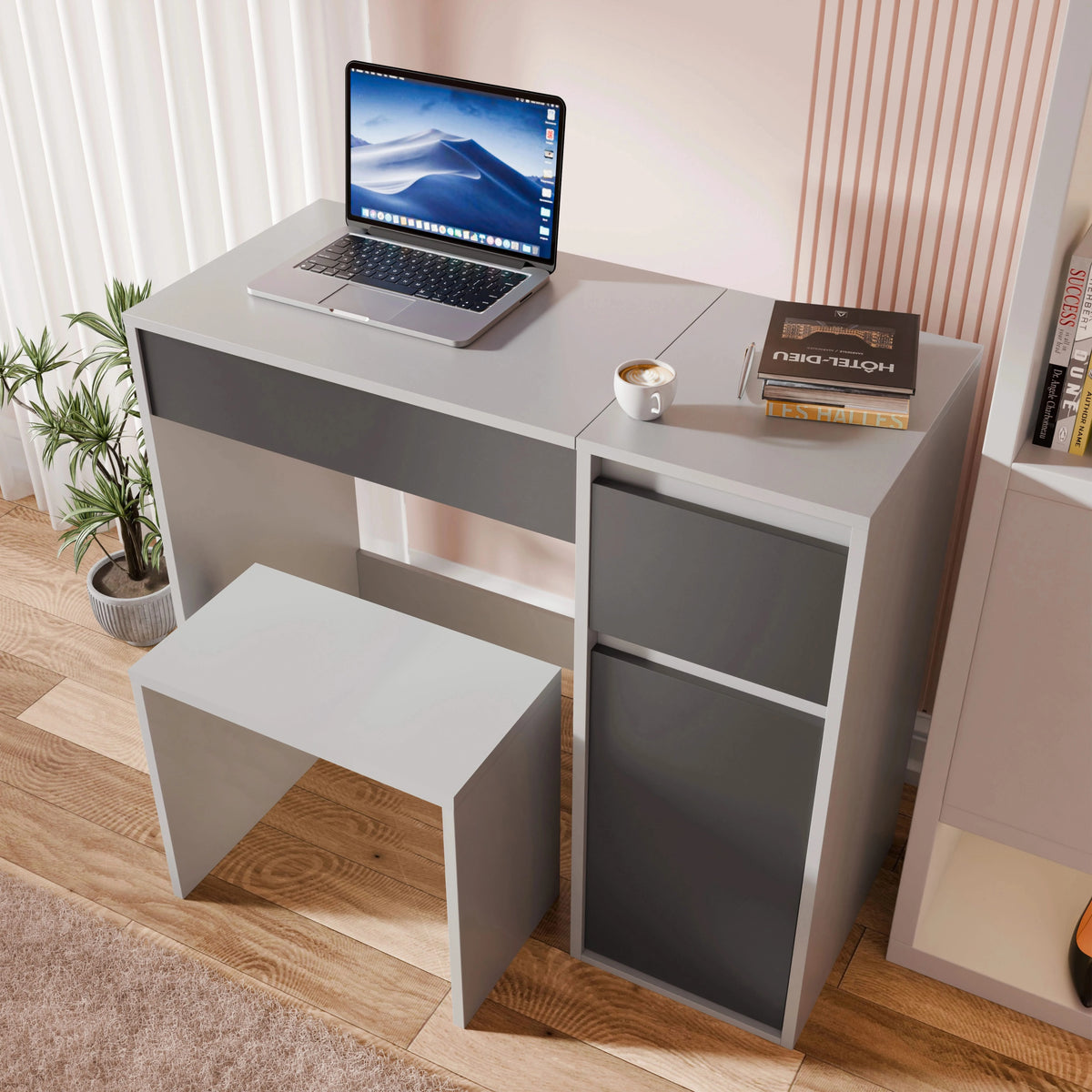 [Grey]  desk with a laptop, books, and a cup on a wooden floor.