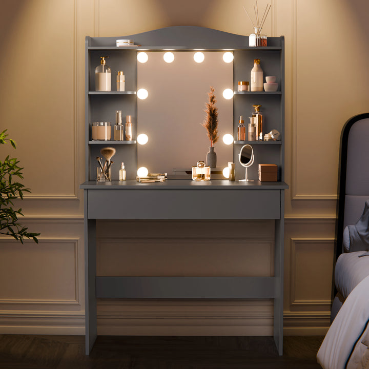 [Grey]  Front view of grey dressing table with mirror and storage shelves neatly arranged with cosmetics and decor items