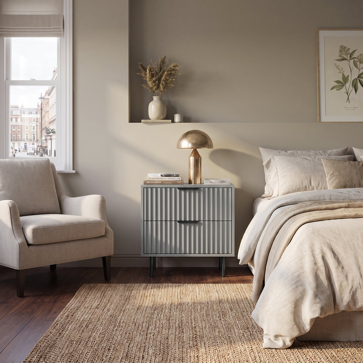 [Grey] Grey Fluted 2 Drawer Bedside Table styled next to a bed in a modern room set.