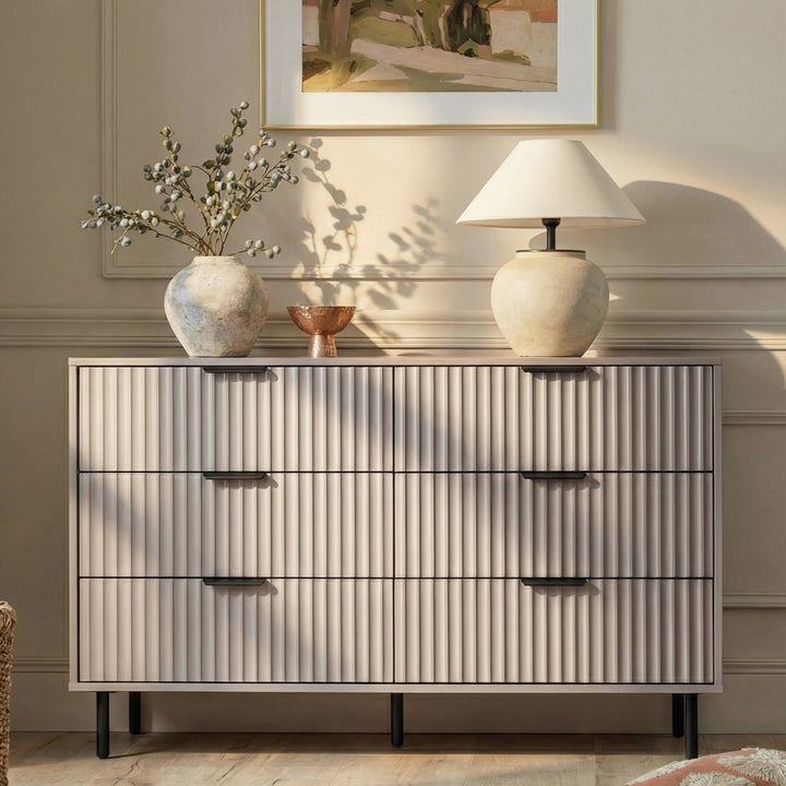 [Grey] Flutrina 6-drawer chest styled in a warm beige bedroom with vase, lamp and wall art