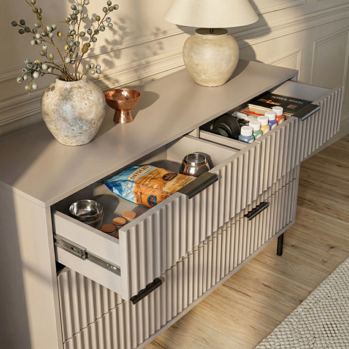[Grey] Flutrina dresser at an angle with two drawers open revealing deep interior filled with everyday items
 