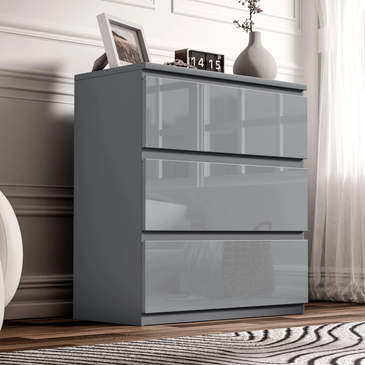 [Grey] high gloss 3 drawer chest styled against white panelled wall with clock and decor