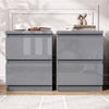 [Grey] Two modern nightstands with a glossy high-shine finish, shown side by side against a white paneled wall with decorative books and a coffee cup on top.