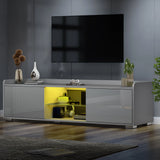 [Grey] grey TV unit angled shot with TV above and herringbone wood floor in light-filled room