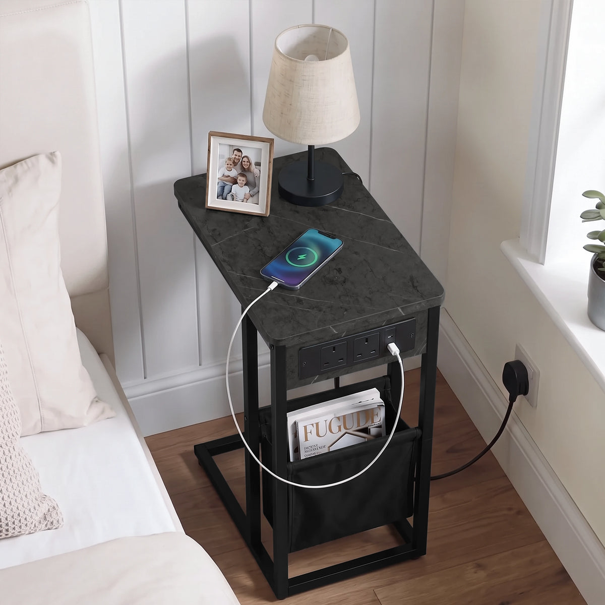 [Grey Marble] Top view of C-shaped side table with marble-effect top, charging cable, phone and pouch used as bed side table