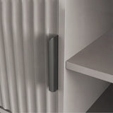 [Grey] Grey fluted door close-up with single dark handle, interior shelf edge visible to the right.