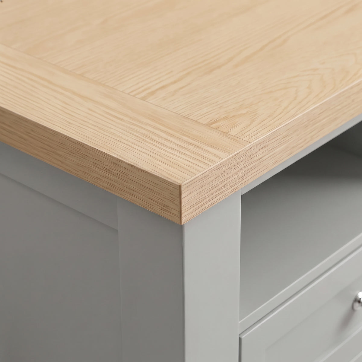 [Grey] Close-up detail of the natural oak effect top surface corner on the Oskara Grey Painted TV Unit.