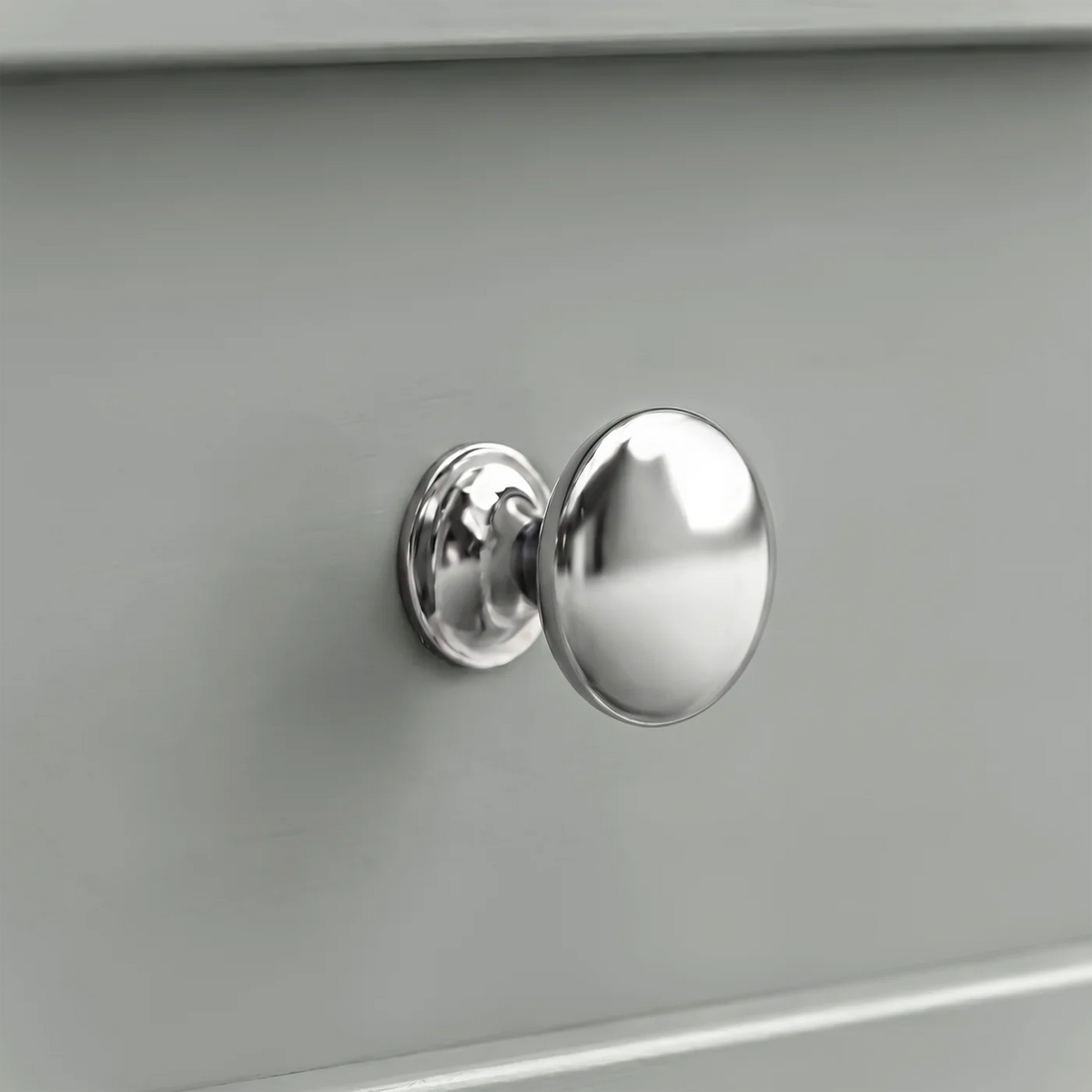 [Grey] Close-up shot of the polished chrome round knob handle on the Oskara Grey Painted TV Unit drawer.