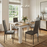 [4 Seater | Grey] Dining Table and Chairs Set with four grey ribbed chairs in a bright panelled dining room with garden view, chandelier, and flower centrepiece