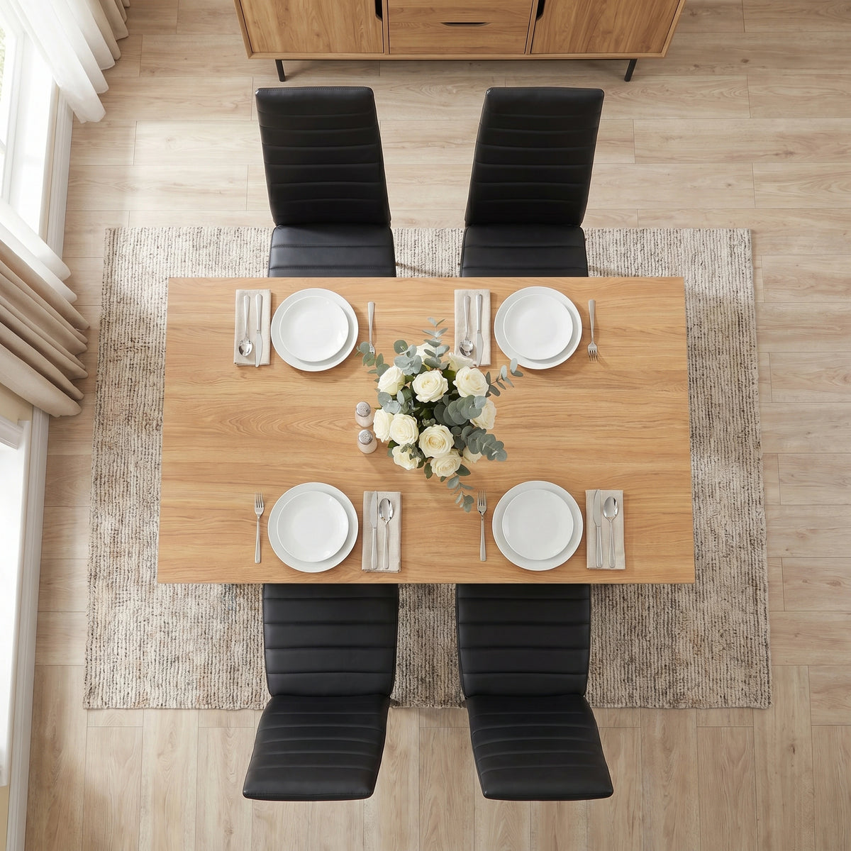 [4 Seater | Black] Grey & Pine 4-6 Seater Dining Table overhead view with four black chairs and four white place settings on a rug