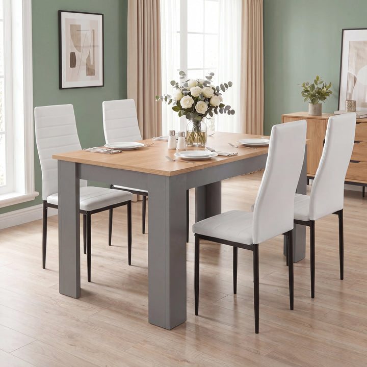 [4 Seater | White] Angled high-angle view of a Grey & Pine 4-6 seater dining table with four white faux-leather chairs.