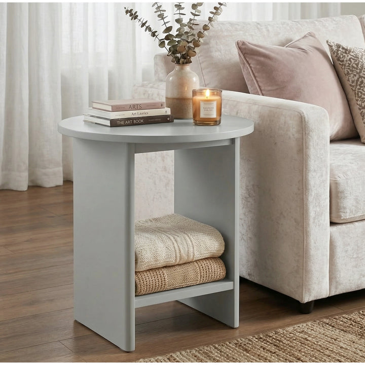 [Grey] Small Round Side Table with Shelf Living Room beside cream sofa with stacked books and lit candle on top and folded throws on lower shelf