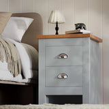 [Grey] angled view of grey shaker nightstand with cup handles oak effect top lamp and ornament on top
