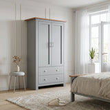 [Grey] Shaker wardrobe in bedroom with closed double doors, lower drawers, oak top, window, bed, and stool.