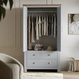 [Grey] Shaker wardrobe with doors open, showing hanging rail, clothing, handbag, hat, drawers, and wall art.