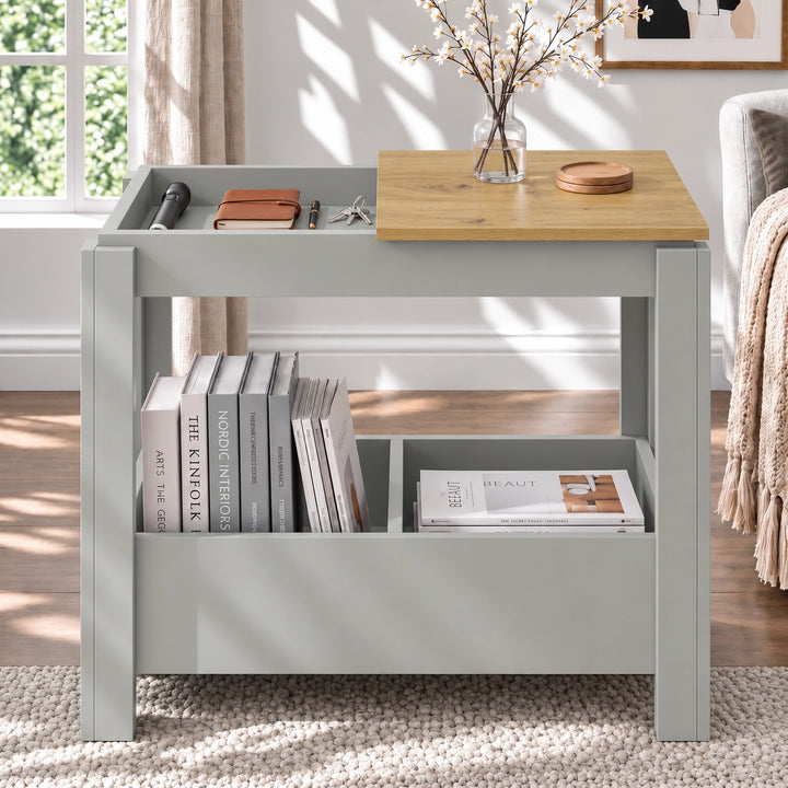 [Grey] Front view showing an open tabletop compartment, a blossom vase on the remaining panel and books underneath.