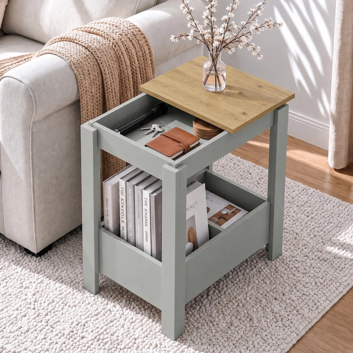 [Grey] Overhead view of open side table storage beside a sofa, with a blossom vase on top and books stored below.