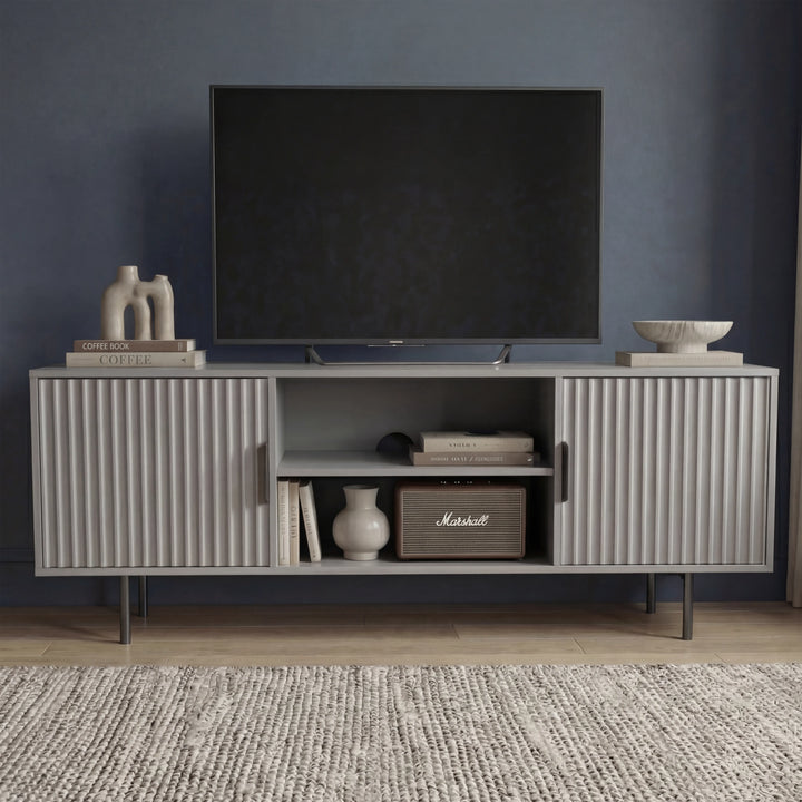[Grey]  Front view of grey Flutrina 140cm TV unit, two ribbed doors closed and open centre showing books and Marshall speaker