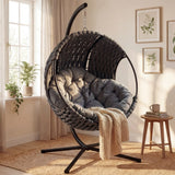 [Dark Grey] Indoor dark grey woven hanging egg chair on jute rug, side table with mug and potted plant nearby
