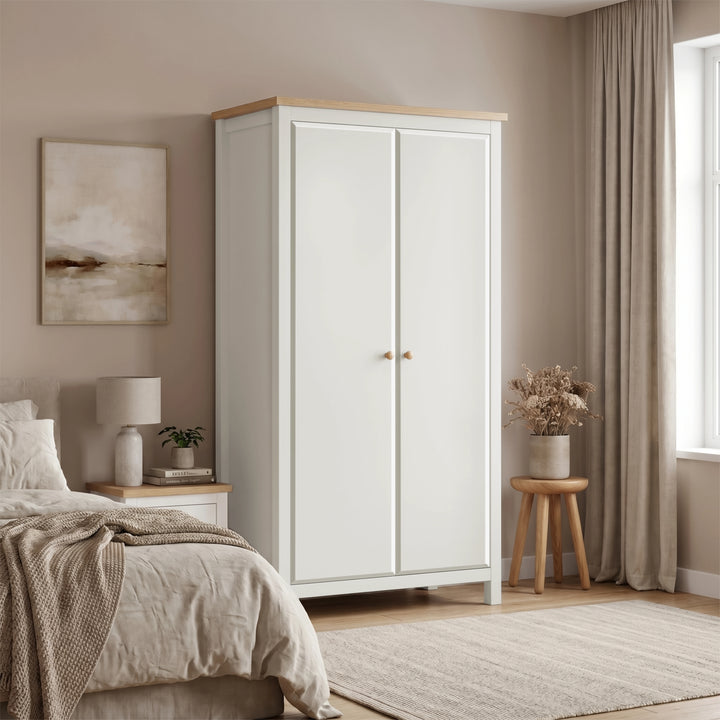 [White] wardrobe in a bedroom with a bed, lamp, and window