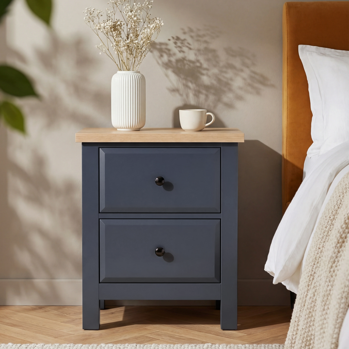 [Blue] Haven bedroom furniture set 2-drawer bedside with oak top and black round knobs beside a bed
