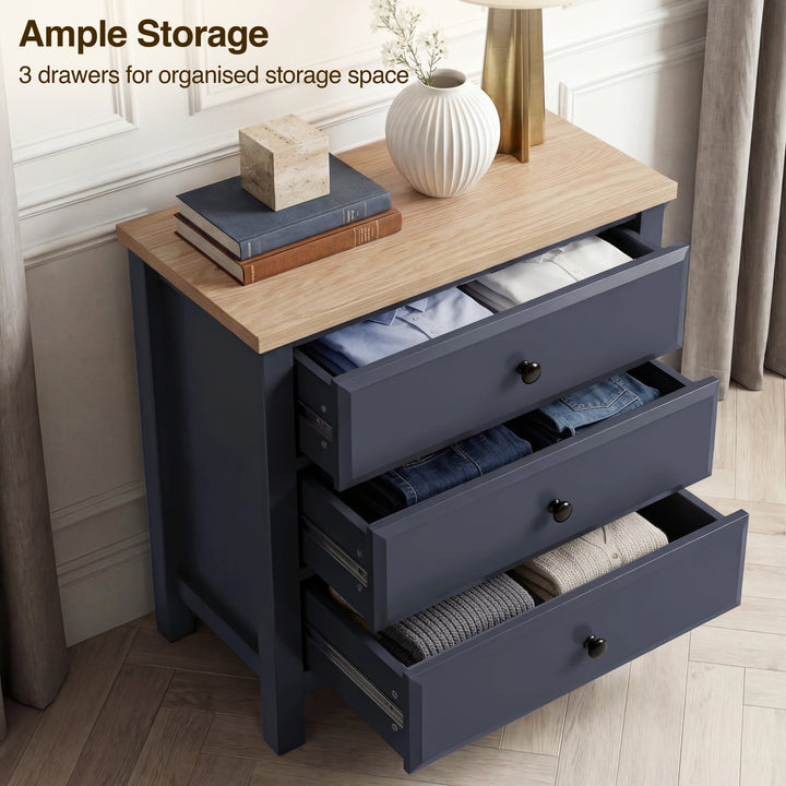 [Blue] Haven bedroom furniture set chest three drawers pulled out, folded clothes inside, black knobs on fronts