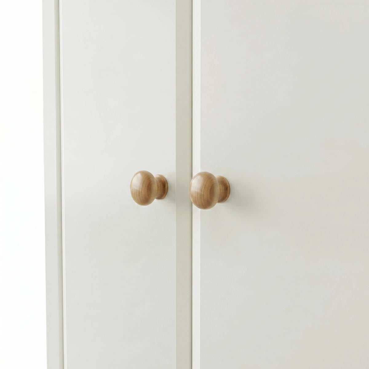 [White] Haven 2 door wardrobe knob detail, turned oak handles sitting centrally where the two white doors meet
