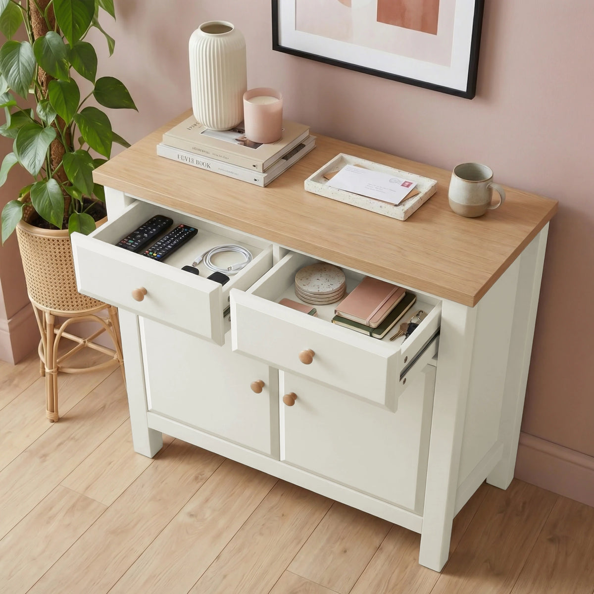 [White] sideboard with wooden top in a room with a plant and framed picture