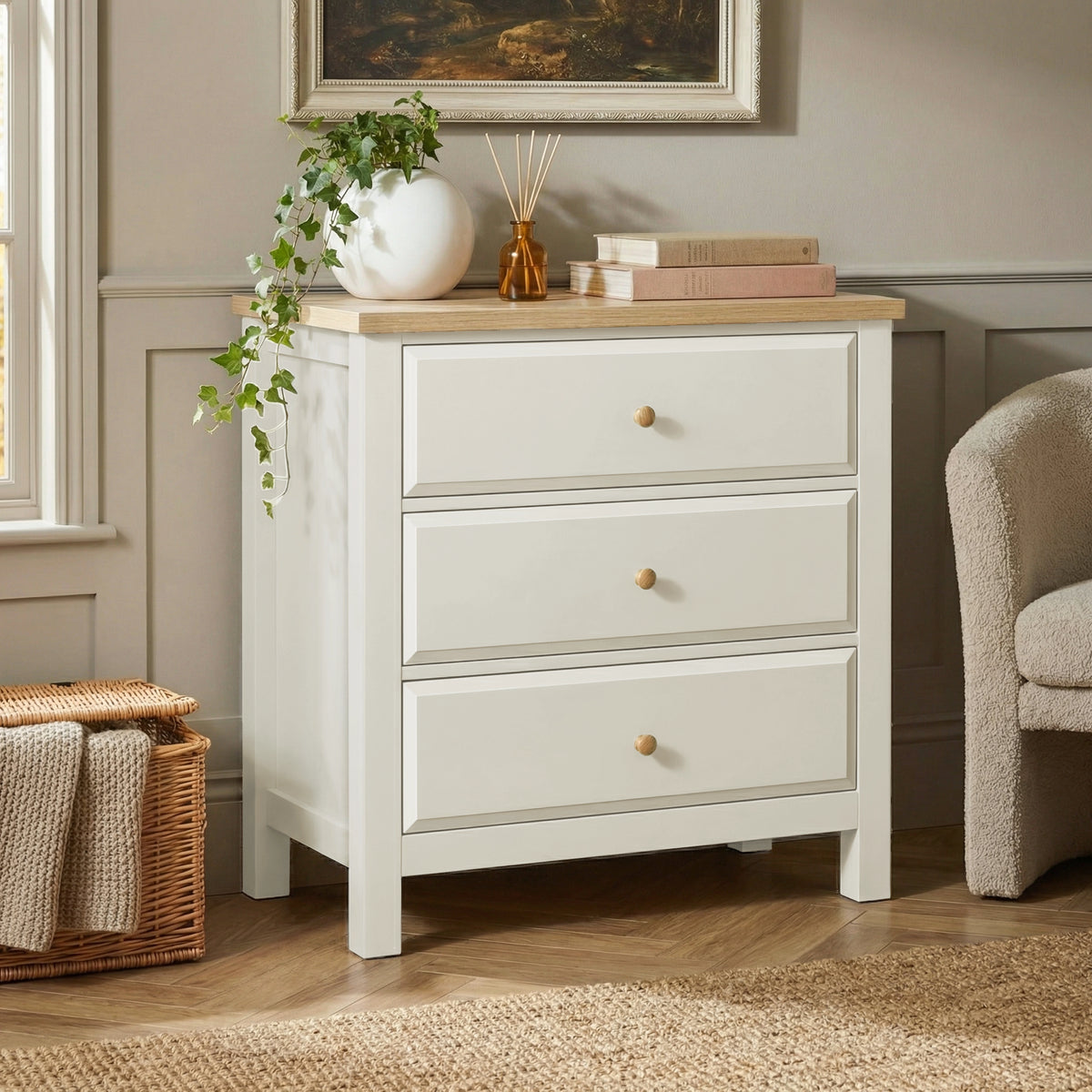 [White] Haven 3-drawer chest in a bedroom with framed artwork above and decorative accessories on oak veneer top