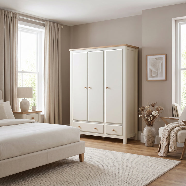 [White] Haven White 3 Door Wardrobe With Drawers and Adjustable Shelves styled nicely in a modern cream bedroom setting.