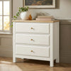 [White] dresser with wooden top in a room with a window and framed picture