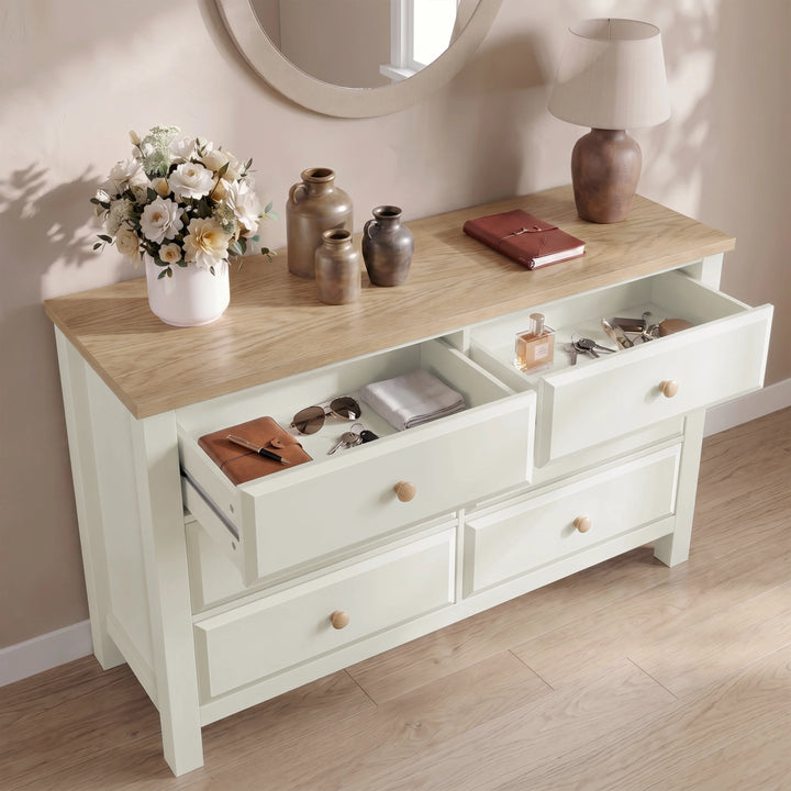 [White] dresser with open drawers containing various items, on a wooden floor