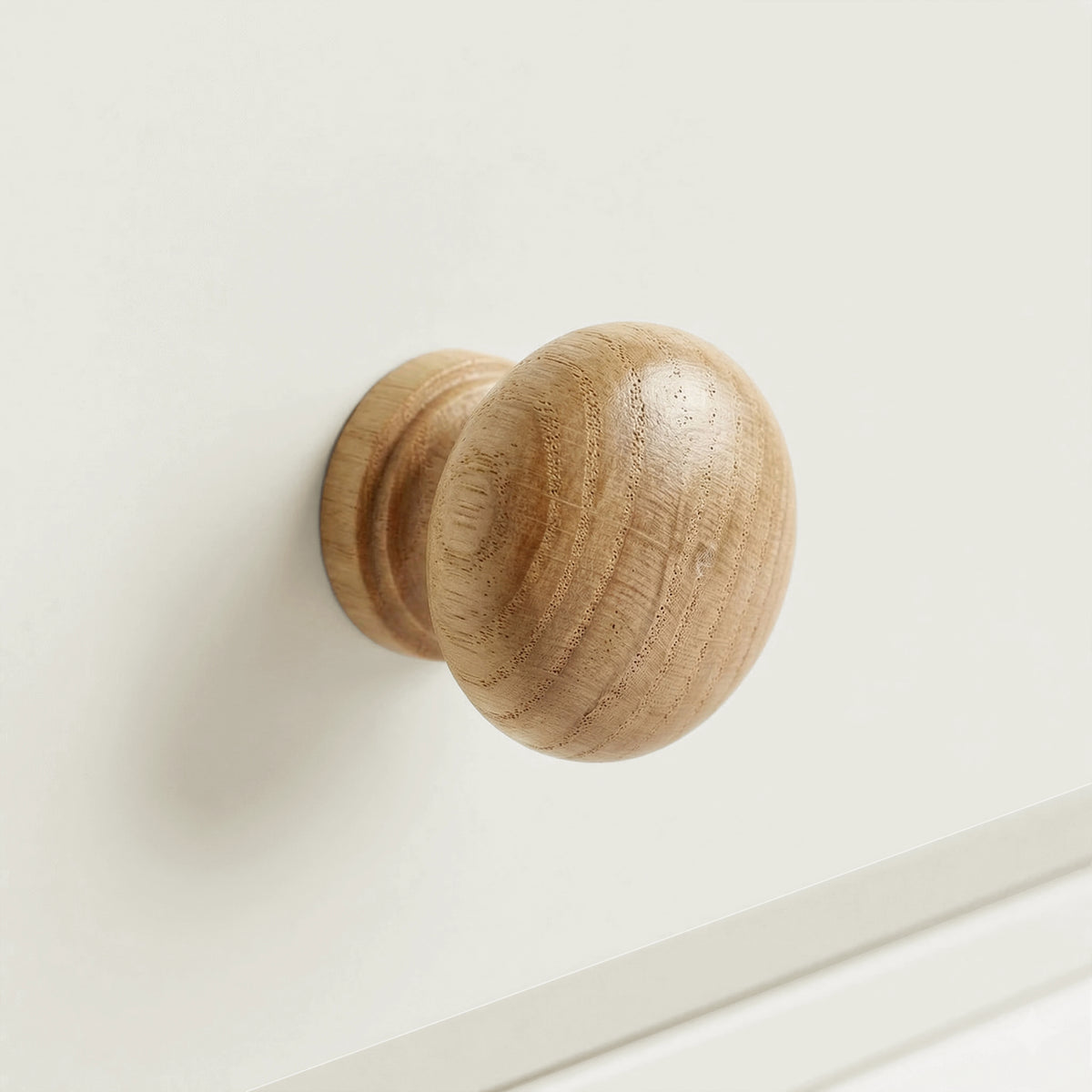 [White] Haven 5-drawer tall chest close-up of a round solid oak wooden knob handle on a painted drawer front