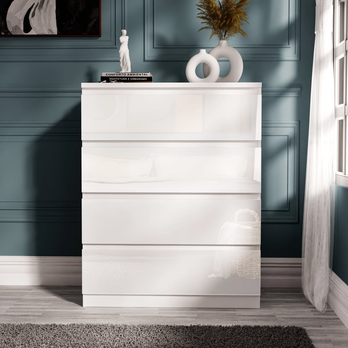 [White] white gloss 4 drawer chest standing alone, drawers closed, decorative figure on top surface