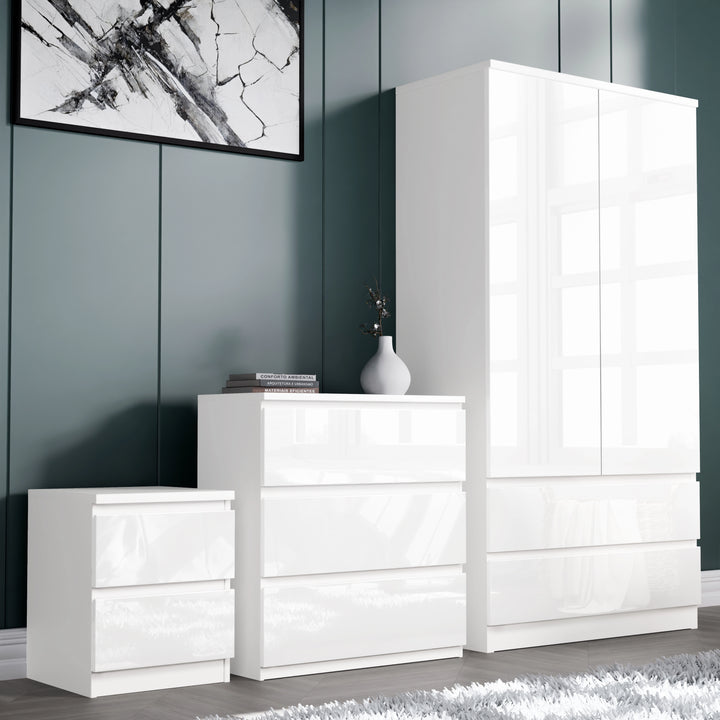 [White] high gloss wardrobe right, 3 drawer chest centre and 2 drawer bedside left against teal panelled wall