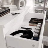 [White] White 4 Drawer Chest of Drawers top drawer interior, headphones beside hardback book labelled HOTEL-DIEU.