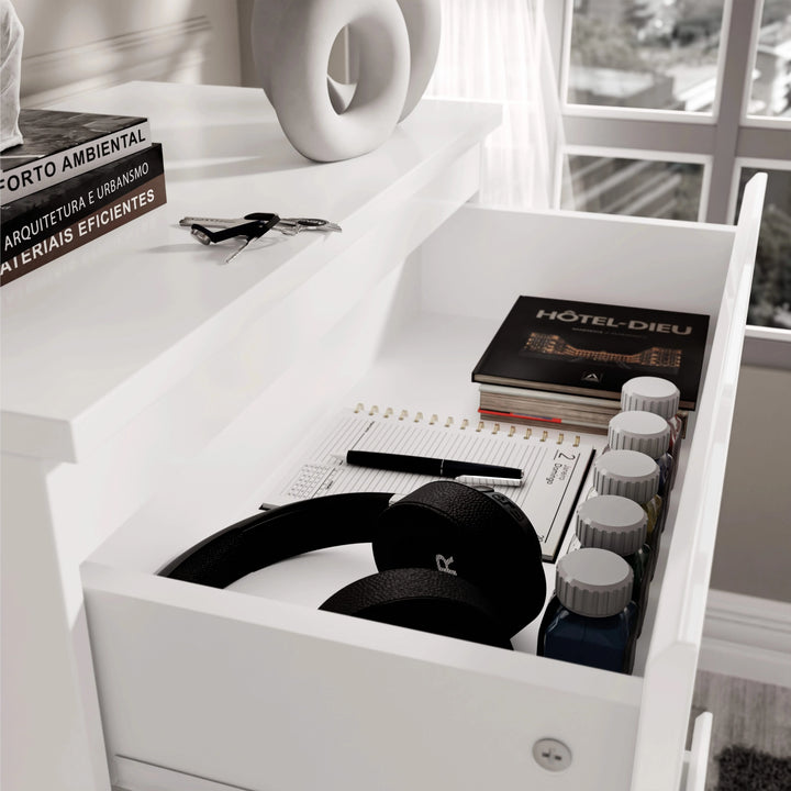 [White] White 4 Drawer Chest of Drawers top drawer interior, headphones beside hardback book labelled HOTEL-DIEU.