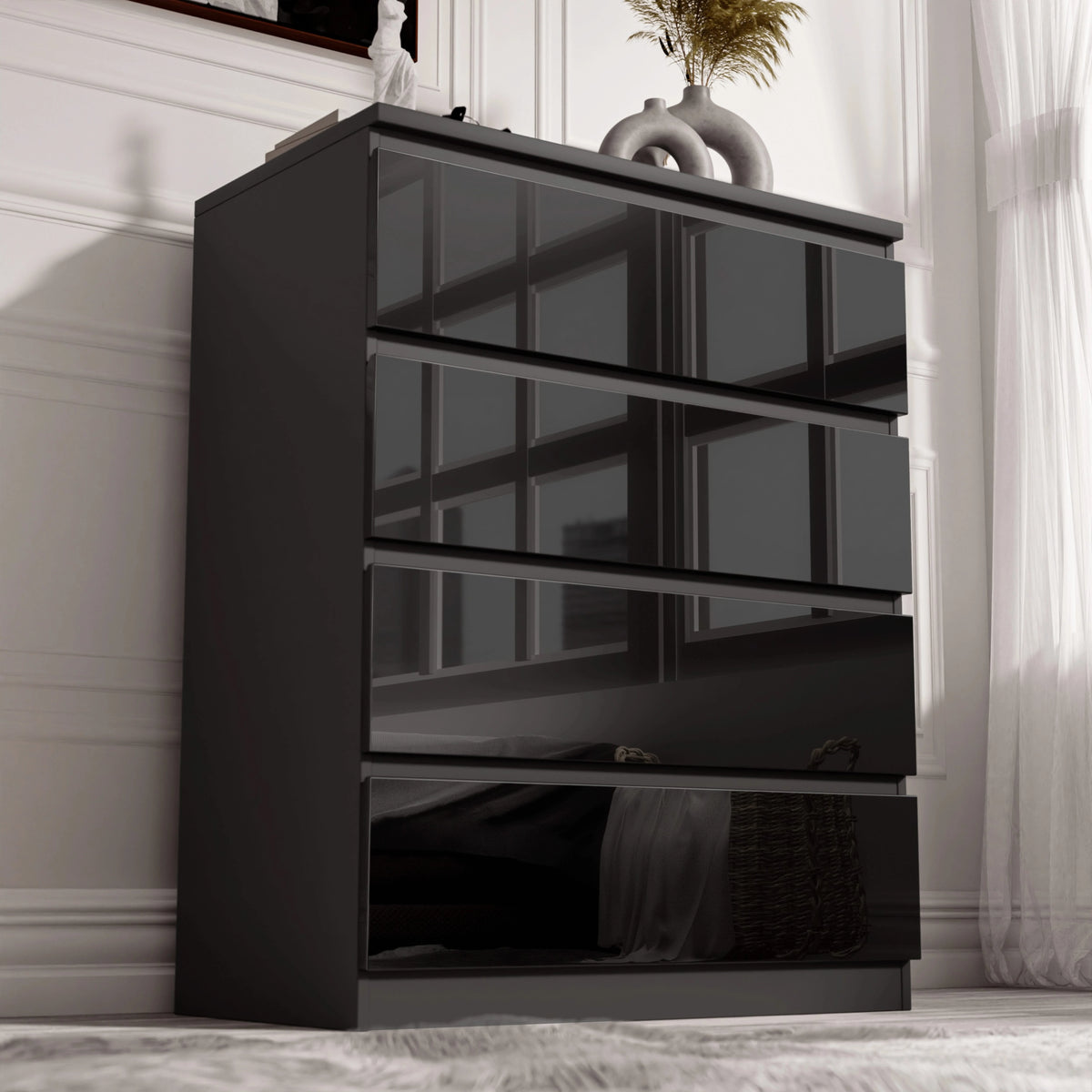 [Black] Angled view of the black High Gloss 4 Drawer Chest of Drawers, gloss fronts reflecting window panes vertically.