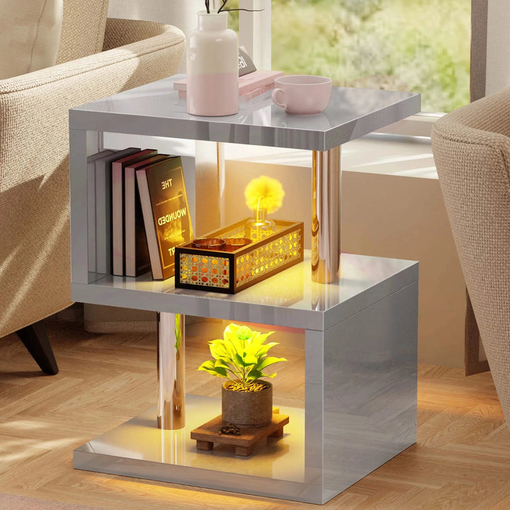 [Grey] Grey S-shape side table front view with potted plant on bottom tier and warm yellow LED accent