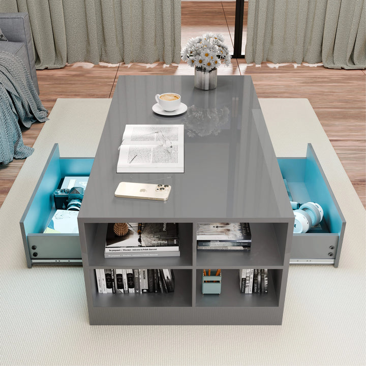 [Grey] Grey high gloss LED coffee table seen from above with side drawers open and books in shelves