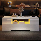 [White] Angled view of white gloss LED coffee table in front of dark leather sofa, yellow lighting on