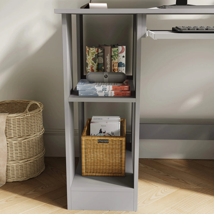 [Grey] Side cube detail of small computer desk in grey with stacked books and rattan basket on lower shelf