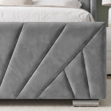 [King | Grey] close-up of a gray upholstered bed frame corner with geometric channel tufting and a metallic footboard support, shown in a bedroom setting