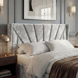[King | Silver] Close view of Sunrise wing headboard with pleated panels, pillows, and brass bedside lamp