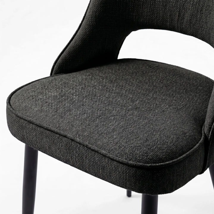 [Black] Close-up of Kyvon 4-seater black upholstered fabric comfy curve chair seat with black metal legs
