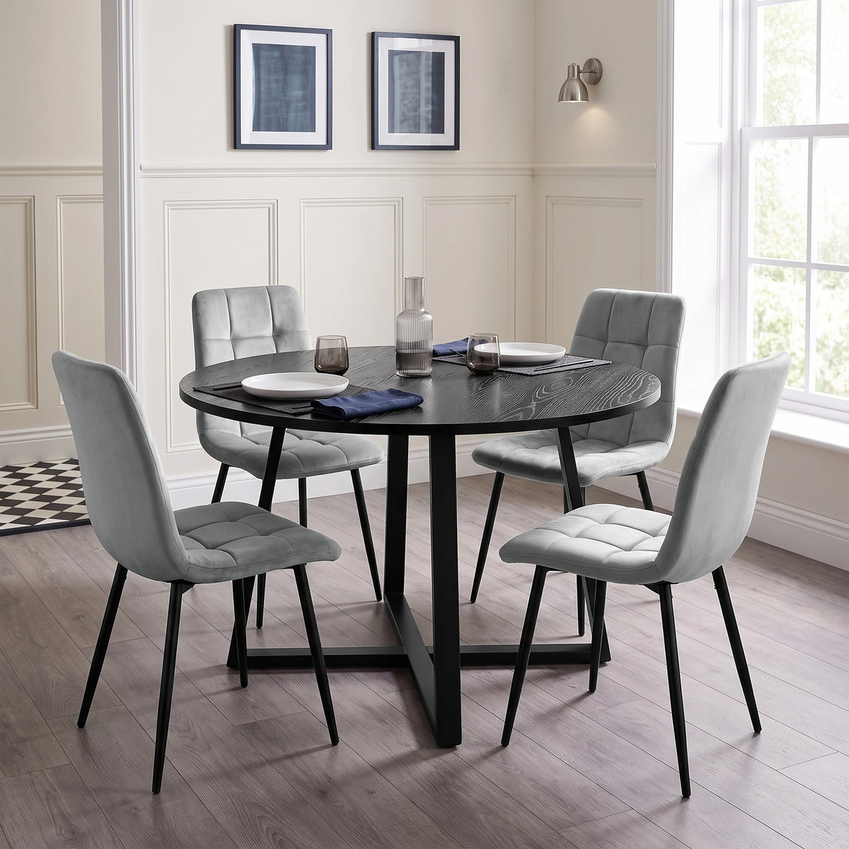 [Light Grey | Black Wood] Kyvon round dining table set in panelled dining room with four light grey velvet chairs